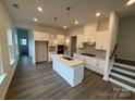 Bright kitchen features modern white cabinets, stainless appliances, hardwood floors, and stylish pendant lighting at 3103 Beacon Heights Rd, Indian Land, SC 29707
