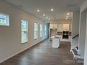 Open-concept living space with large windows and hardwood floors offering lots of natural lighting at 3103 Beacon Heights Rd, Indian Land, SC 29707