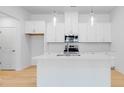 Bright, modern kitchen with stainless steel appliances and a large island at 3107 Beacon Heights Rd, Indian Land, SC 29707