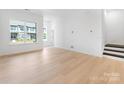 Spacious living room with large windows and hardwood floors at 3107 Beacon Heights Rd, Indian Land, SC 29707