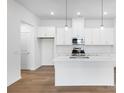 Modern kitchen featuring white cabinets, stainless steel appliances, a stylish backsplash and a center island at 3109 Beacon Heights Rd, Indian Land, SC 29707