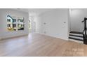 Open concept living space with hardwood floors, large windows, and ample natural light at 3111 Beacon Heights Rd, Indian Land, SC 29707