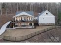 Lakefront property showcasing house, detached garage, and expansive yard at 42610 Moonshine Dr, New London, NC 28127