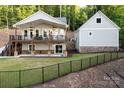 Stunning two-story home featuring a spacious porch with ceiling fans and lush landscaping at 42610 Moonshine Dr, New London, NC 28127
