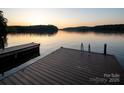 Beautiful lake view at sunset from the dock with calm water reflecting the colorful sky at 42610 Moonshine Dr, New London, NC 28127