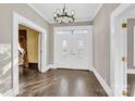 Bright entry with hardwood floors, chandelier, and elegant double doors at 550 Woodleaf Barber Rd, Cleveland, NC 27013