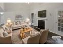Virtually staged living room with fireplace and neutral decor at 6041 Pinebark Ct, Charlotte, NC 28212