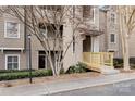Exterior view of condo building with wood facade, wooden ramp, and trimmed green bushes at 9801 Emerald Point Dr # 2, Charlotte, NC 28278