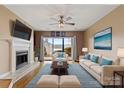 Comfortable living room featuring a fireplace, a large window with water view, and modern furniture at 9801 Emerald Point Dr # 2, Charlotte, NC 28278