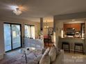 Inviting living room with an open layout flowing into the dining area and a breakfast bar at 11121 S Harrowfield Rd, Charlotte, NC 28226