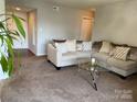 Comfortable living room featuring plush seating, neutral decor, and ample space at 11121 S Harrowfield Rd, Charlotte, NC 28226