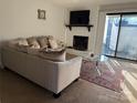Cozy living room with fireplace, sliding glass doors, and comfortable sofa at 11121 S Harrowfield Rd, Charlotte, NC 28226