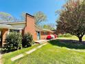 Attractive brick home with lush front lawn, vibrant azaleas, and a charming blue front door at 1160 Nw 11Th Street Cir, Hickory, NC 28601