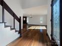 Bright entryway with hardwood floors, staircase, and views to living room at 122 Cricket Creek Dr, Cherryville, NC 28021