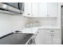 Modern kitchen with white cabinets and quartz countertops at 1233 Rollingwood Dr, Charlotte, NC 28217