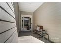 Cozy front porch with a bench and lantern, perfect for relaxing at 14207 Asbury Park Rd, Huntersville, NC 28078