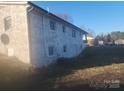 Backyard view of a two-story white painted brick home on a sunny day at 1918 Kingston Rd, Kingstown, NC 28150