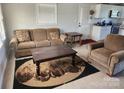 Cozy living room featuring a comfortable sofa, armchair, and view to the kitchen at 1918 Kingston Rd, Kingstown, NC 28150