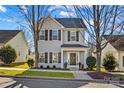 Two-story house with gray siding, black shutters, and a front porch at 19510 Deer Valley Dr, Cornelius, NC 28031