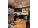Modern kitchen featuring stainless steel appliances and dark cabinetry at 201 Hoskins Rd # 115, Charlotte, NC 28208