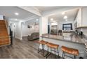 Open concept living space features wood flooring, a breakfast bar, and a comfortable lounging area at 2752 Peachtree Rd, Statesville, NC 28625