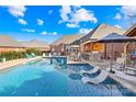 Stunning backyard featuring a large pool, outdoor kitchen, and cozy lounge area, perfect for entertaining at 311 Kaitlyn Ln, Kings Mountain, NC 28086