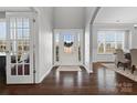 Bright foyer with hardwood floors, a glass-paneled front door, and views into the formal dining and living areas at 334 Cotton Field Rd, Indian Land, SC 29707