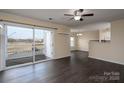 Living room with dark floors and access to a balcony at 3809 Carl Parmer Dr, Harrisburg, NC 28075