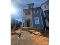 Charming two-story blue home with a welcoming front porch and bright, natural light at 421 Delburg Mill Alley Dr, Davidson, NC 28036