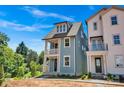 Charming two-story blue home with a front porch, landscaped yard, and mature trees at 421 Delburg Mill Alley Dr, Davidson, NC 28036