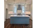 Modern kitchen with a large island, stylish pendant lighting, and white cabinetry, creating a chic culinary space at 421 Delburg Mill Alley Dr, Davidson, NC 28036