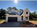 Bright, newly built home shows detailed architecture with dormer windows and black window frames at 426 Richards Ln, Mooresville, NC 28115