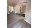 Spacious living area with light wood flooring, an arched entry, and fresh paint, ready for your personal touch at 426 Richards Ln, Mooresville, NC 28115