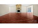 Living room with hardwood floors and a stone fireplace at 500 Kirby Ln, Matthews, NC 28104