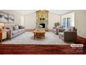 Virtually staged living room featuring stone fireplace and hardwood floors at 500 Kirby Ln, Matthews, NC 28104