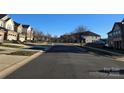Street view of a neighborhood with townhouses and landscaping at 5860 Clan Maclaine Dr, Charlotte, NC 28278