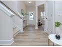 Bright and airy entryway with light wood floors and staircase at 710 N Cedar St, Lincolnton, NC 28092