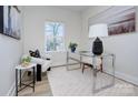 Charming home office with glass desk, comfy chair, and natural light at 710 N Cedar St, Lincolnton, NC 28092