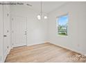 Bright dining room with hardwood floors and a chandelier at 10006 Travis Floyd Ln # 002, Charlotte, NC 28214