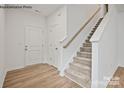 Light and airy entryway with hardwood floors and staircase at 10006 Travis Floyd Ln # 002, Charlotte, NC 28214