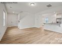 Open living room with hardwood floors and kitchen views at 10006 Travis Floyd Ln # 002, Charlotte, NC 28214