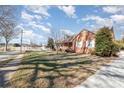 Side view of brick house showcasing landscaping at 107 E Boyd St, Maiden, NC 28650