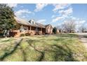 Side view of brick house with yard and street at 107 E Boyd St, Maiden, NC 28650