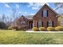 Brick home with a manicured lawn and walkway at 254 Streamside Pl, Mooresville, NC 28115
