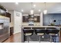 Open kitchen with island, granite counters, and stainless steel appliances at 3033 Honeylocust Ln, Fort Mill, SC 29707