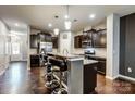 Features include a large island, granite countertops, dark cabinetry, and stainless appliances at 3033 Honeylocust Ln, Fort Mill, SC 29707