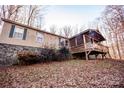Mobile home with a large wooden deck overlooking a wooded area at 338 Piney Grove Rd, Harmony, NC 28634