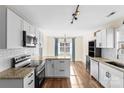 Modern kitchen featuring granite countertops and white cabinets at 4702 Powder Horne Ln, Conover, NC 28613