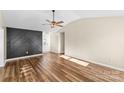 Bright living room with hardwood floors and modern wall accents at 4702 Powder Horne Ln, Conover, NC 28613