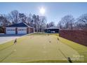 Backyard with a private putting green, detached garage, and plenty of room for recreation at 7169 Pleasant Grove Rd, Charlotte, NC 28216